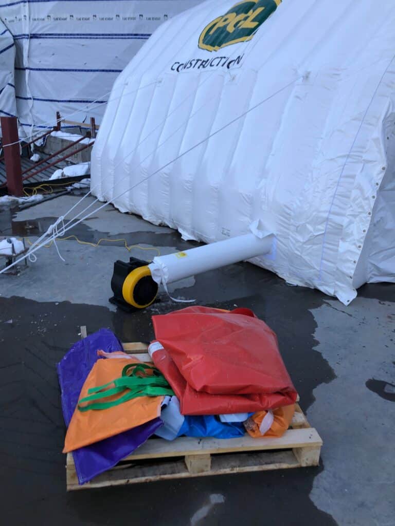 Njordair Fast Tent during set-up with installation equipment staged alongside