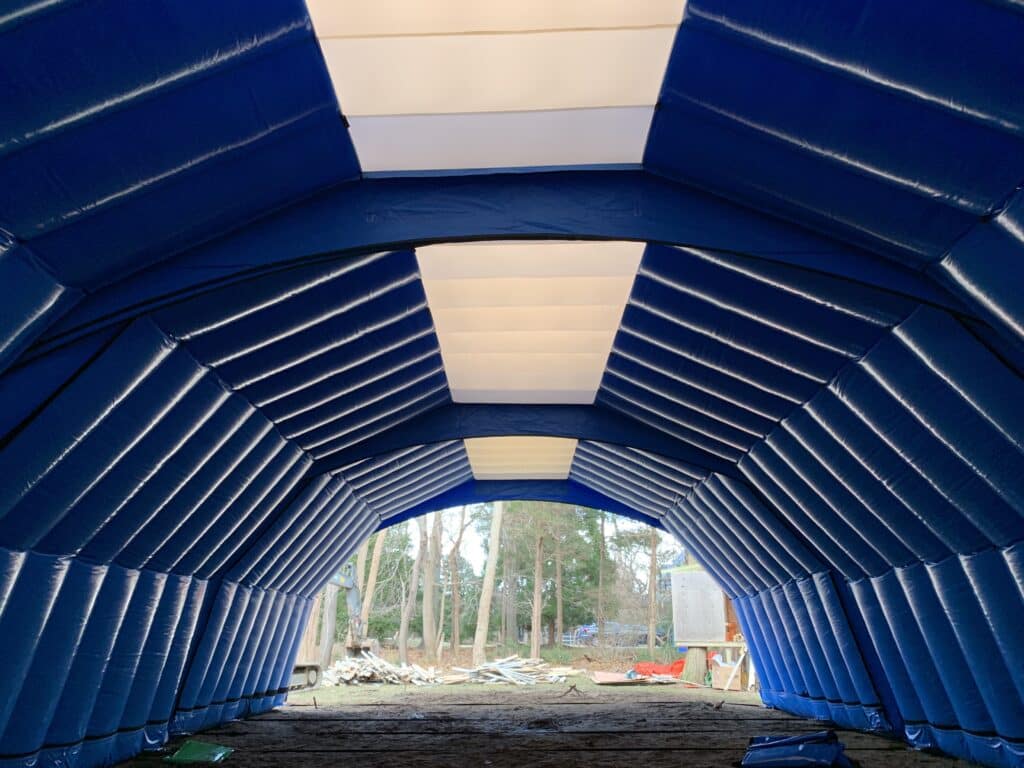 Translucent roof panels lighting the interior of the Njordair pool construction enclosure