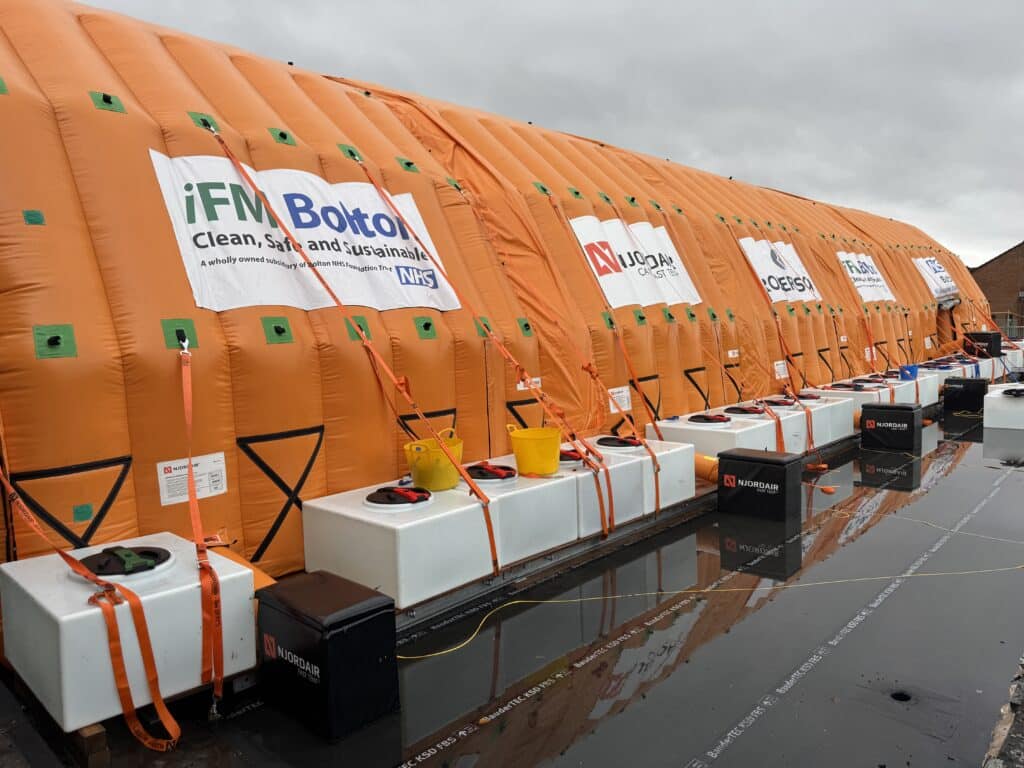 Njordair Constant Air modules with iFM Bolton NHS branding covering the hospital roof replacement