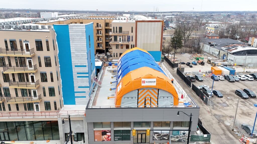 Orange and blue Njordair Fast Tent on the rooftop of the mixed-use building