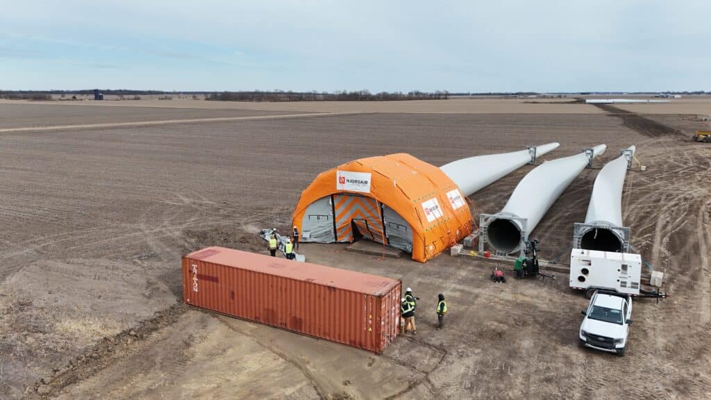 Njordair shelter positioned over turbine blades on open farmland